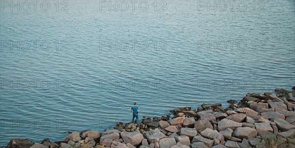 A man fishing by the sea