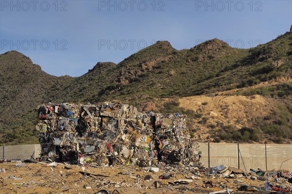 Crushed metal waste in cube on scrap yard