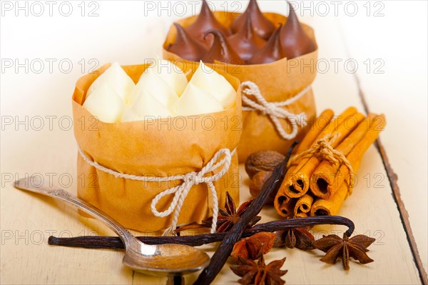 Fresh baked chocolate vanilla and spices cream cake dessert over rustic wood table