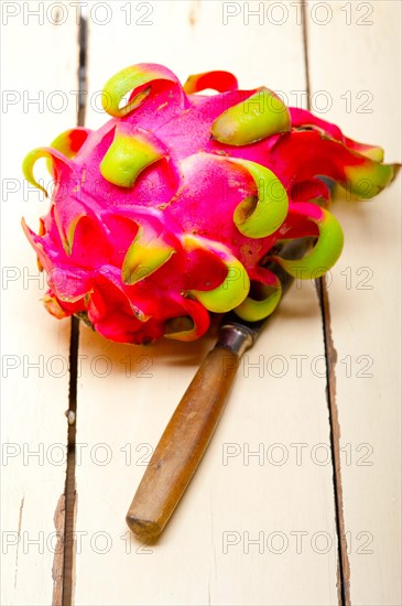 Fresh thai purple dragon fruit over white rustic table