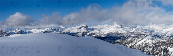 Blue sky over winter landscape and snowy peaks