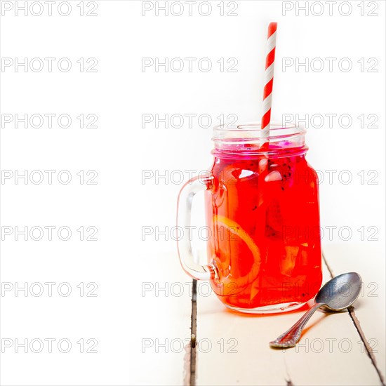 Fresh fruit punch refreshing summer drink over white rustic wood table