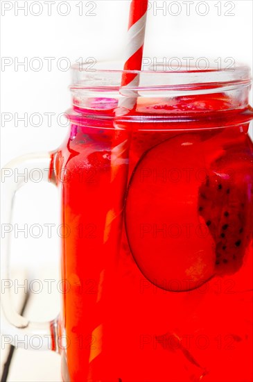 Fresh fruit punch refreshing summer drink over white rustic wood table