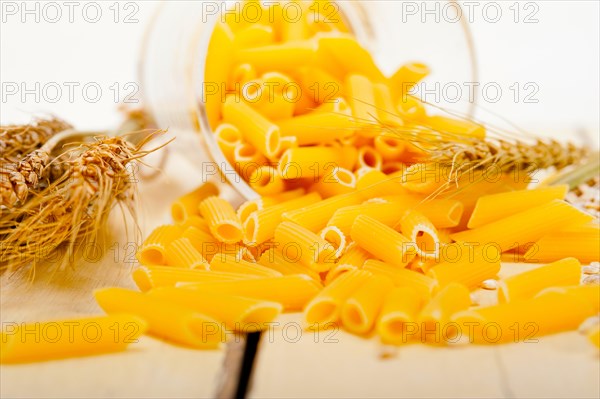 Short Italian pasta penne with durum wheat grains