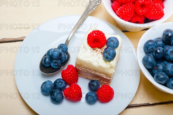 Fresh homemade raspberry and blueberry cream cake