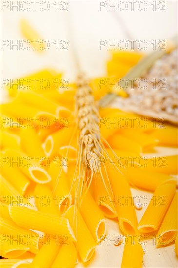 Short Italian pasta penne with durum wheat grains