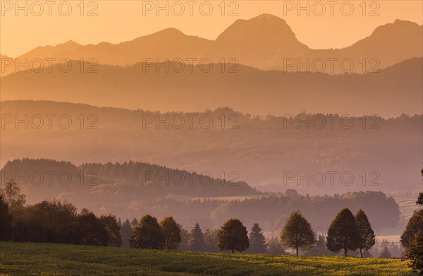 Morning mist in the foothills of the Alps at sunrise at the Wilparting pilgrimage church