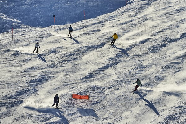 Skiers coming down from the hill
