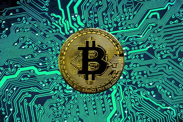 Bitcoin BTC crypto currency gold coins on a mainboard