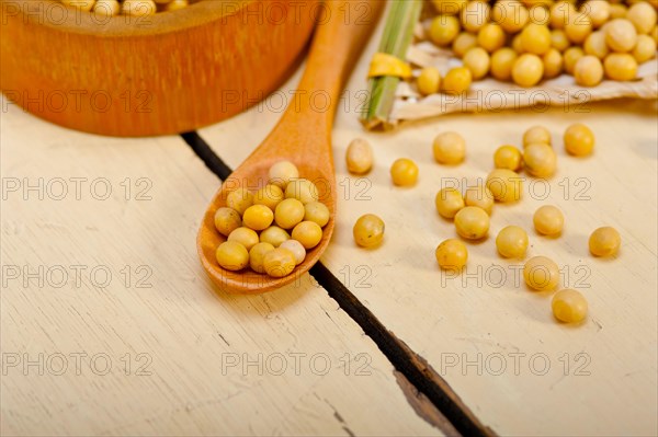 Organic soya beans over rustic wood table macro closeup