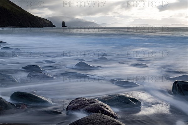 North Atlantic with rock needle and cloudy sky