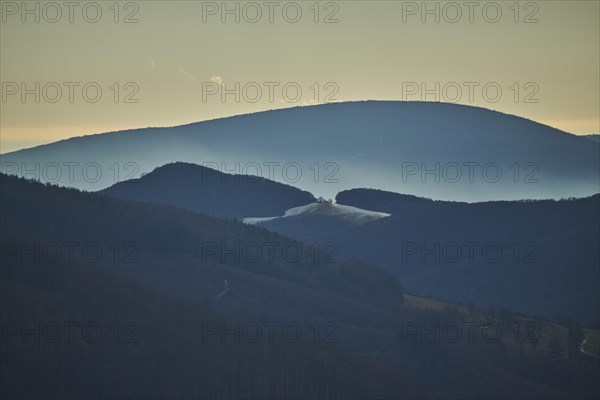 Fog lying in a valley in between to hills