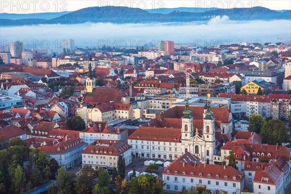 Cityscape of Graz with Mur river and Mariahilfer church