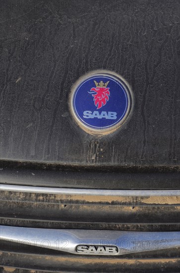 Saab car logo on blue paint