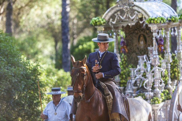 Men in traditional attire with the Simpecado during the annual Romeria of El Rocio