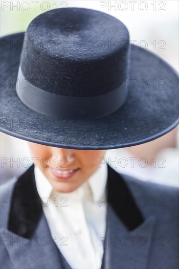 Detail of a young woman in Sombrero and traditional attire during the Feria de Abril