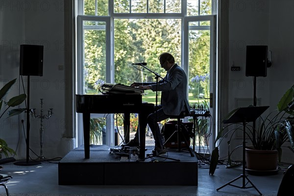 Musician at the piano in the pavilion of the spa hotel