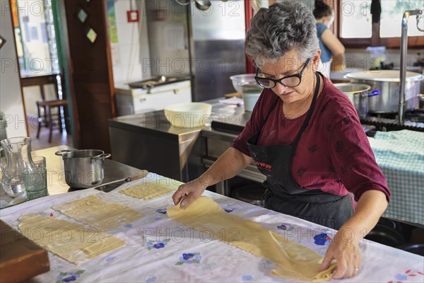 Preparing a lasagne in the kitchen of an agriturismo