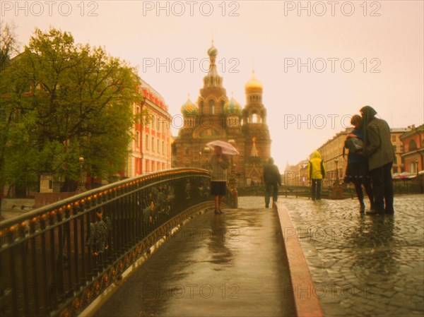 People in front of the Church on Spilled Blood on a bridge above Gribedoyev canal