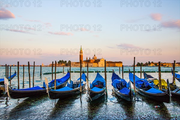 Gondolas in front of the evening panorama of San Giorgio Maggiore