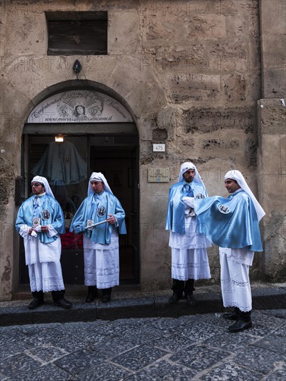 Members of a brotherhood during Good Friday in the streets of Enna