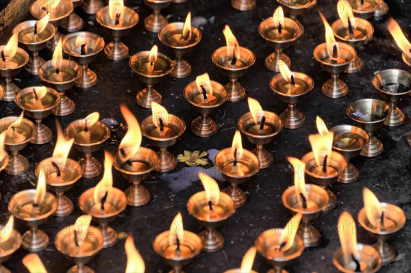 Worshippers light butter lamps