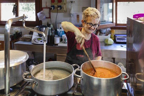 Preparing a lasagne in the kitchen of an agriturismo