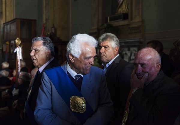 Elderly man in the Cathedral preparing for the celebrations of Easter Sunday in Aidone