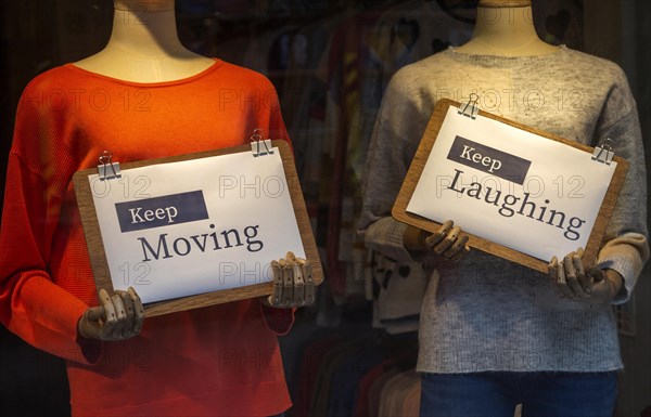 Positive messages during Covid coronavirus lockdown held by mannequins in shop window