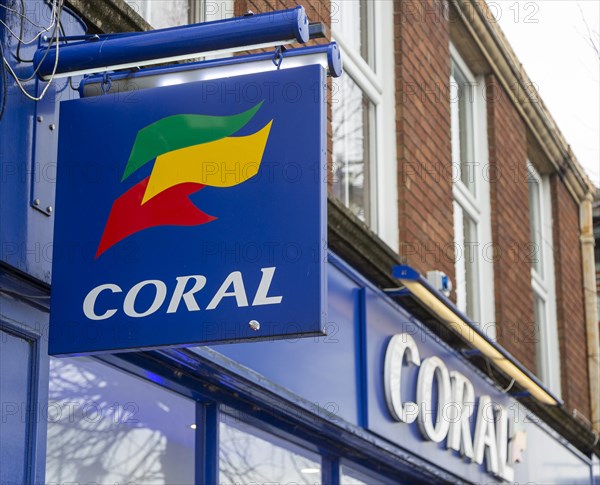 Wall mounted sign outside Coral bookmakers shop