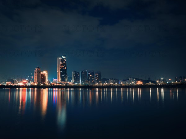 Seaside buildings at night in Macau