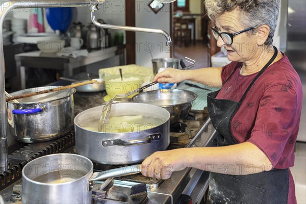 Preparing a lasagne in the kitchen of an agriturismo