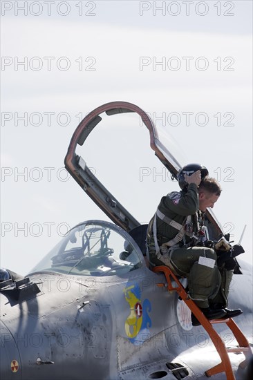 Polish pilot sitting at the edge of a cockpit of the Mikoyan-Gurevich MIG-29 Fulcrum
