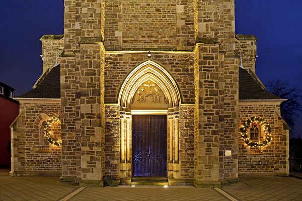 Illuminated entrance to the parish church of St. Suitbertus