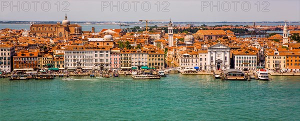 View of the waterfront and Castello district with Pieta church and Chiesa di San Giorgio dei Greci with the leaning tower
