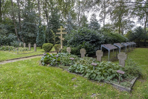 Gravestones for unknown Russian soldiers and Orthodox Russian cross at the cemetery for Soviet prisoners of war from WW2