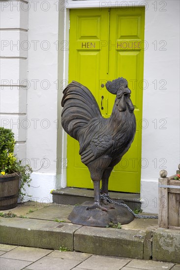 Large metal cockerel sculpture chained outside Hen House