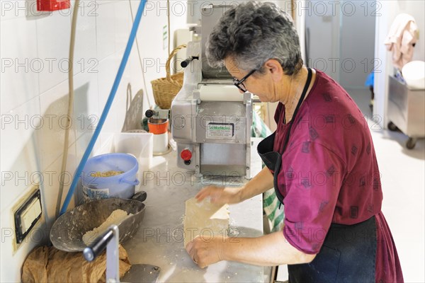 Preparing a lasagne in the kitchen of an agriturismo