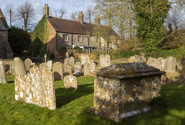 Old weathered stone gravestones in churchyard