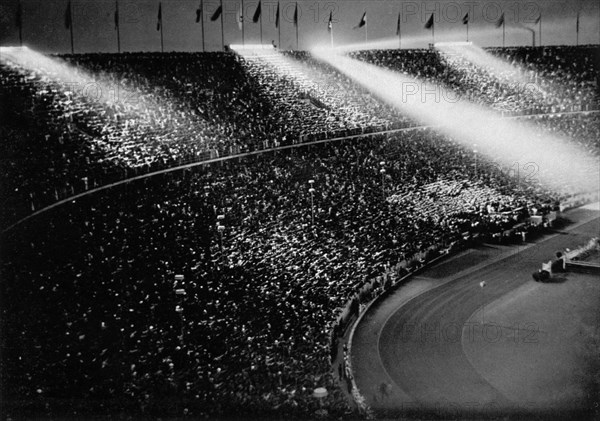 The spotlights chase beams of light over the crowds