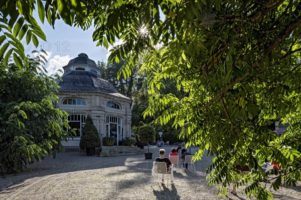 Spa guests sitting at the pavilion of the spa hotel in the spa garden