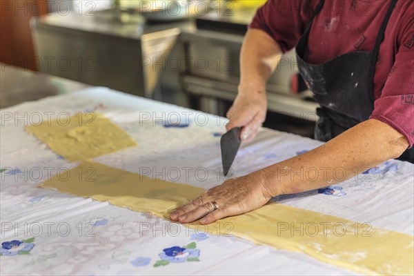 Preparing a lasagne in the kitchen of an agriturismo