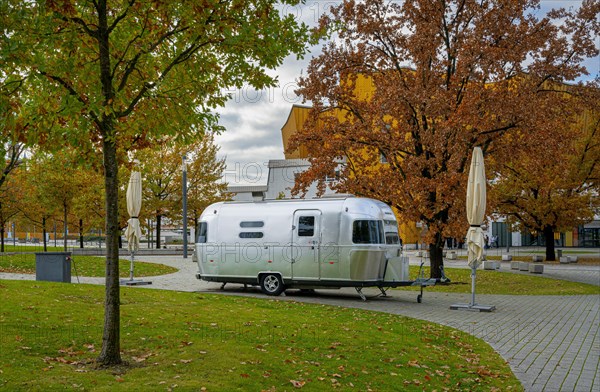 Retro caravan stands in the park next to the Philharmonie