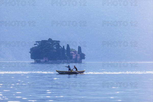 Two men rowing a Naet the traditional boat of the region near Monte Isola