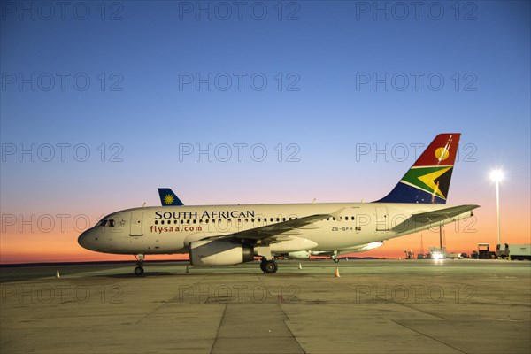 South African Airline on tarmac at sunrise