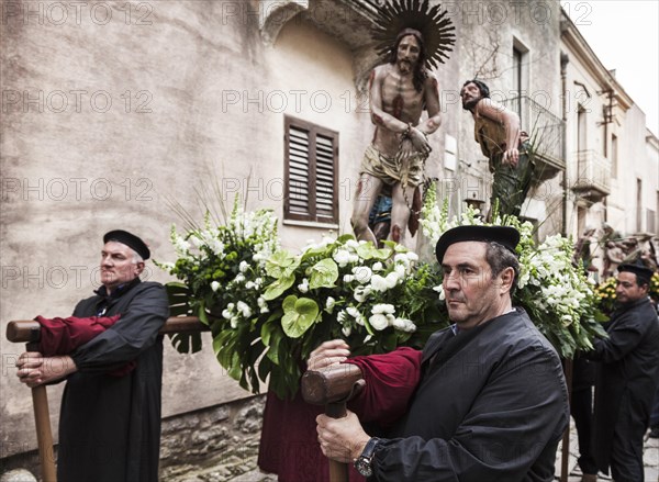 Men taking a rest during the Good Friday processions in the streets of Erice