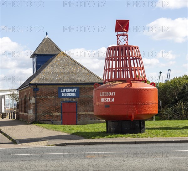 Red navigation buoy Lifeboat Museum building