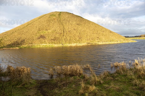 Water filled moat surrounding neolithic prehistoric mound of Silbury Hill