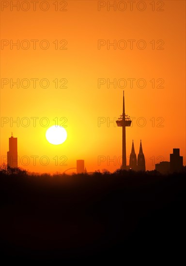 Sunrise over the city skyline with the Colonius telecommunications tower and the cathedral