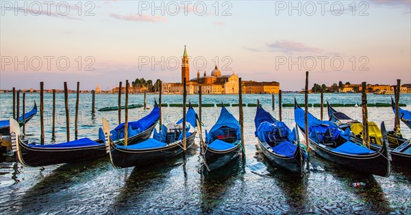 Gondolas in front of the evening panorama of San Giorgio Maggiore